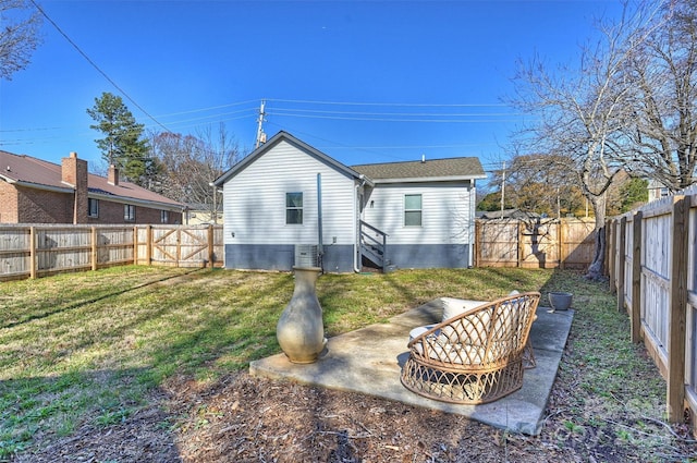 rear view of house featuring a lawn