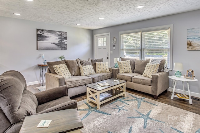 living room with dark hardwood / wood-style floors and a textured ceiling