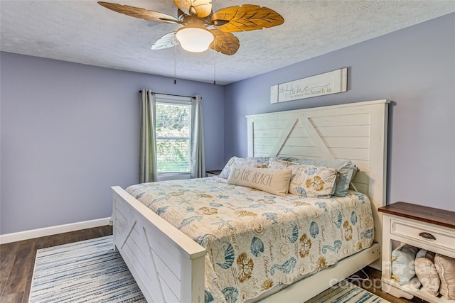 bedroom featuring a textured ceiling, ceiling fan, and dark wood-type flooring