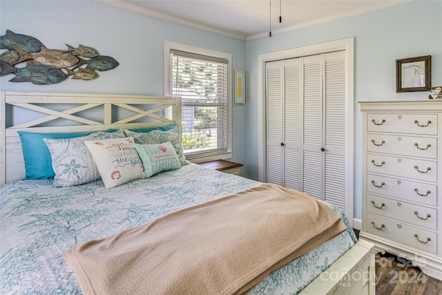 bedroom featuring a closet, wood-type flooring, and ornamental molding