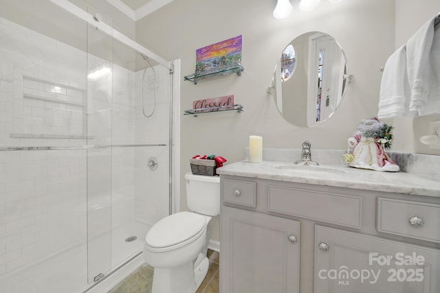 bathroom featuring vanity, ornamental molding, a shower with door, and toilet