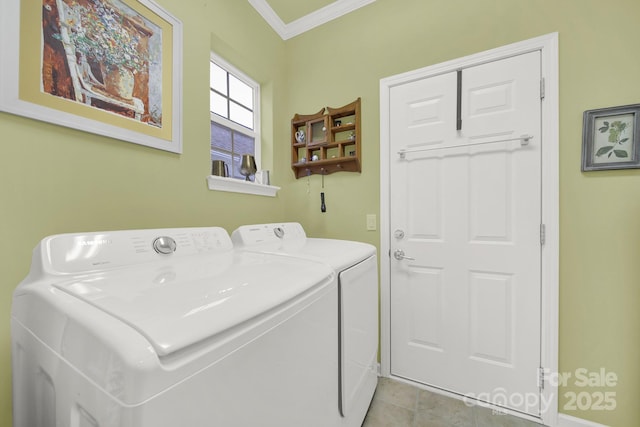 clothes washing area featuring washing machine and dryer, ornamental molding, and light tile patterned floors