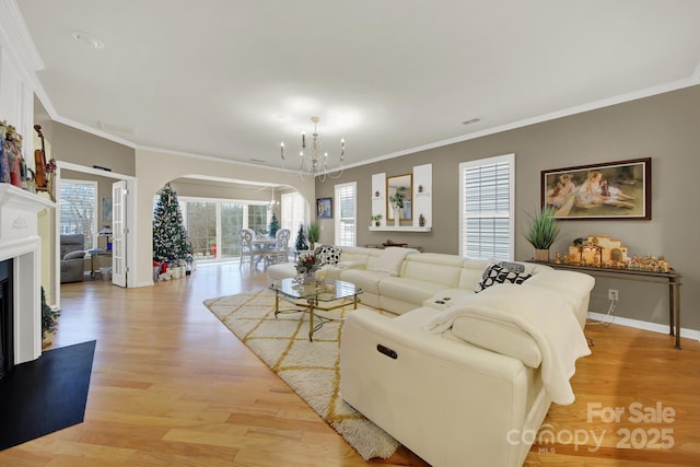 living room featuring light hardwood / wood-style flooring, ornamental molding, and plenty of natural light