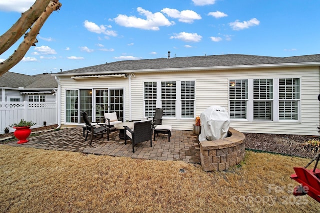 rear view of property with a yard and a patio