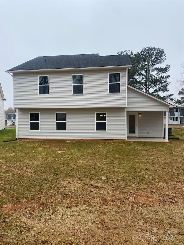 rear view of house with a lawn