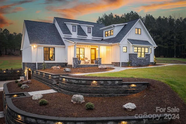 back house at dusk with a yard