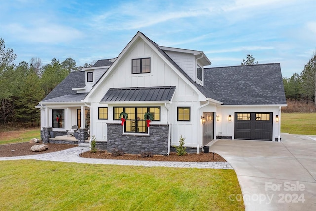 modern inspired farmhouse with a garage and a front lawn