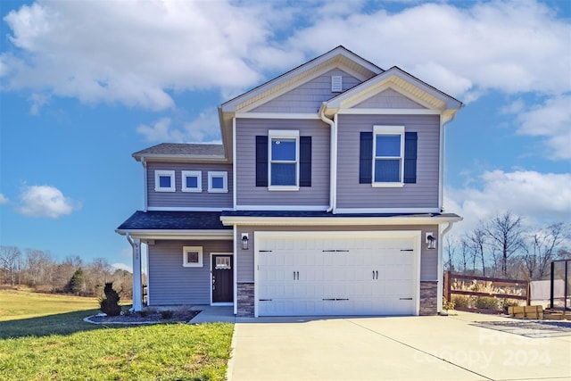 view of front of home with a front yard and a garage