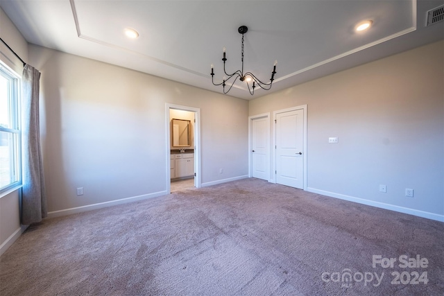 interior space with carpet, a chandelier, and a wealth of natural light