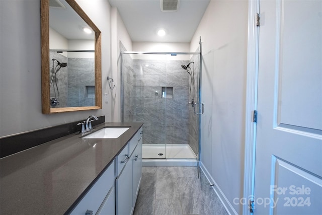 bathroom with vanity and an enclosed shower