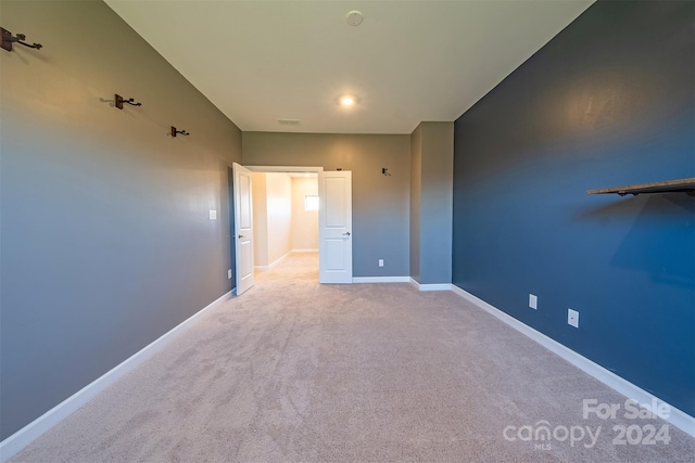 unfurnished bedroom featuring light colored carpet