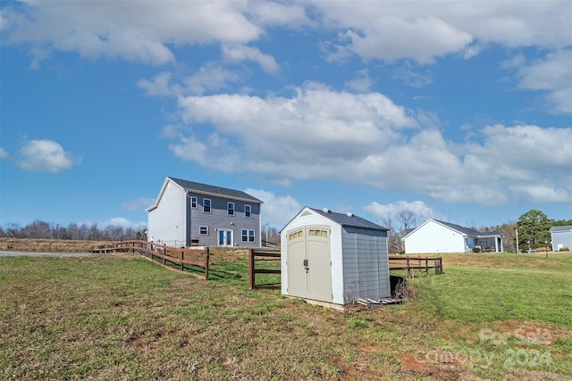 view of yard with a rural view and a storage shed