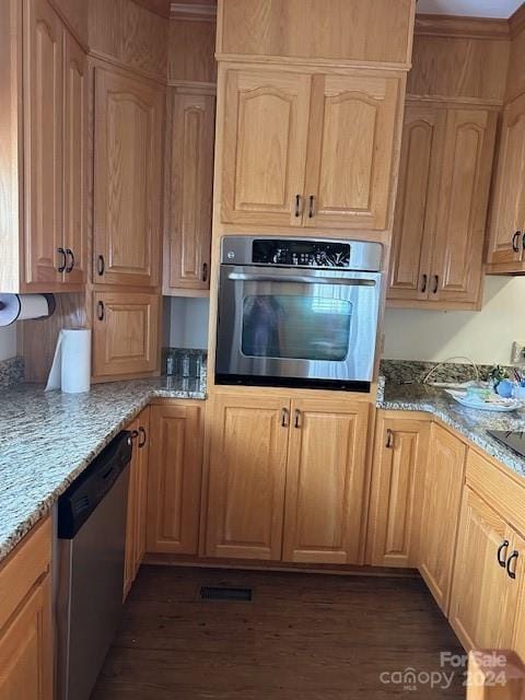 kitchen with light stone counters, dark hardwood / wood-style flooring, and stainless steel appliances