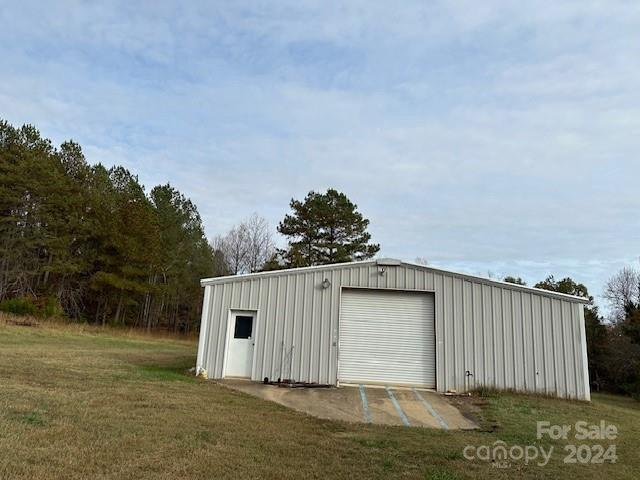 view of outbuilding featuring a yard and a garage