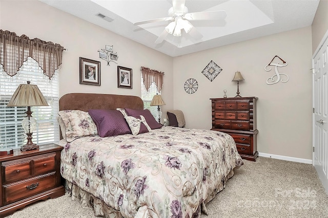 bedroom with ceiling fan, a closet, and light carpet