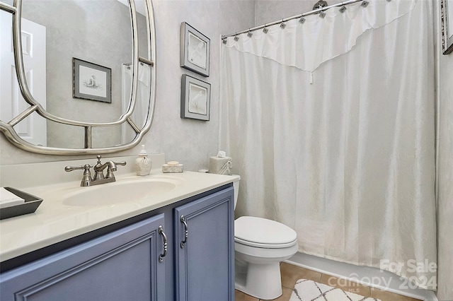 bathroom featuring tile patterned flooring, vanity, toilet, and a shower with curtain