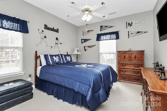 bedroom featuring ceiling fan and light colored carpet