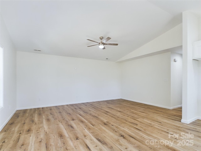 unfurnished room featuring ceiling fan, vaulted ceiling, and light hardwood / wood-style flooring