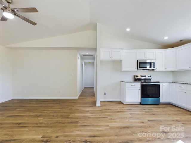 kitchen featuring white cabinetry, ceiling fan, appliances with stainless steel finishes, vaulted ceiling, and light hardwood / wood-style flooring