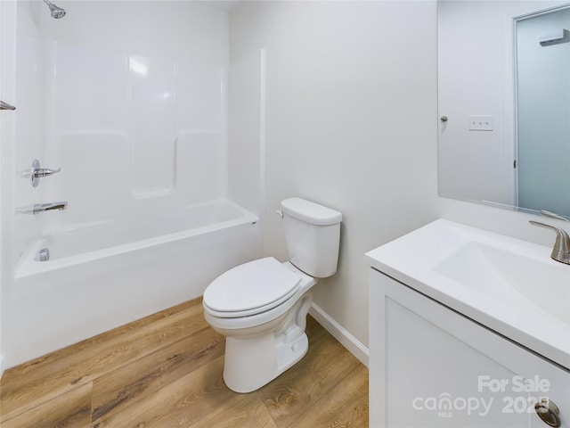 full bathroom with wood-type flooring, toilet, vanity, and shower / tub combination