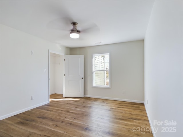 spare room featuring ceiling fan and hardwood / wood-style floors