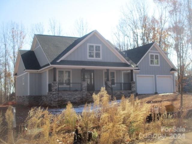 craftsman house featuring covered porch and a garage