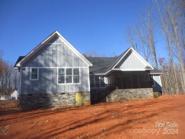 view of home's exterior with a sunroom