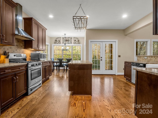 kitchen with a chandelier, stainless steel appliances, and a wealth of natural light