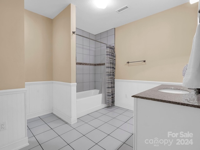 bathroom with tile patterned floors, shower / bath combo, and vanity