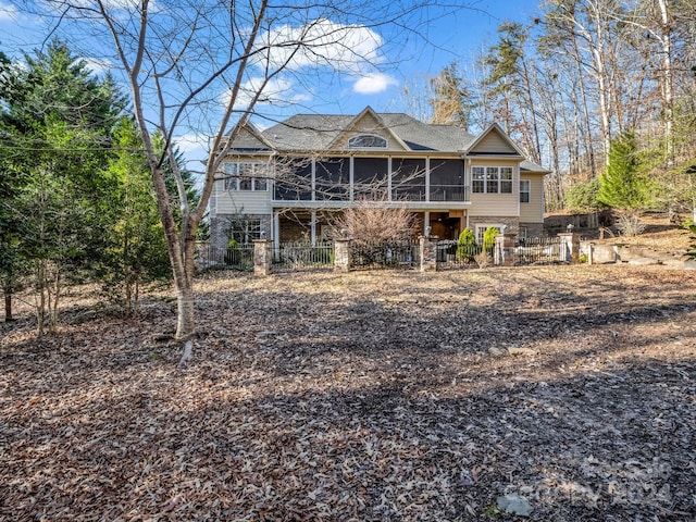 rear view of house featuring a sunroom