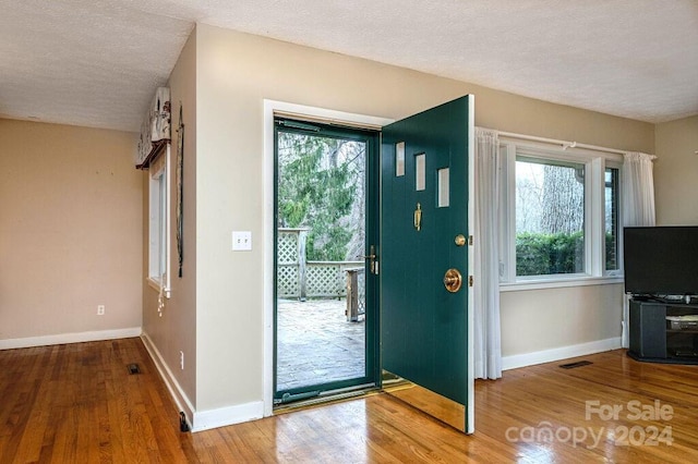 foyer with a textured ceiling and hardwood / wood-style flooring