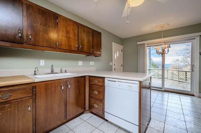 kitchen with sink, kitchen peninsula, white dishwasher, decorative light fixtures, and light tile patterned floors