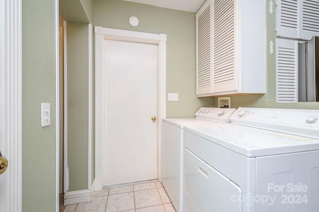 washroom featuring light tile patterned floors, cabinets, and independent washer and dryer