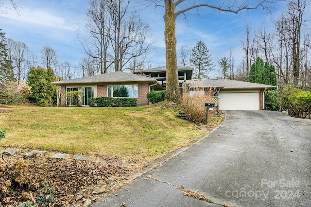 ranch-style home with a front yard and a garage