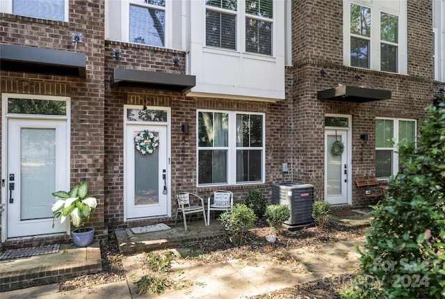 doorway to property featuring central AC unit