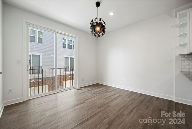 unfurnished dining area featuring dark wood-type flooring