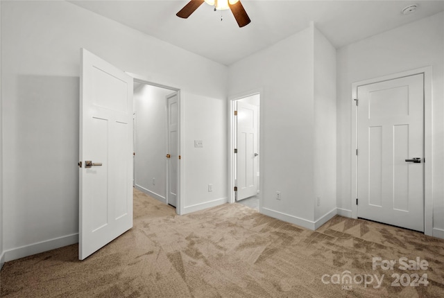 unfurnished bedroom featuring ceiling fan and light colored carpet