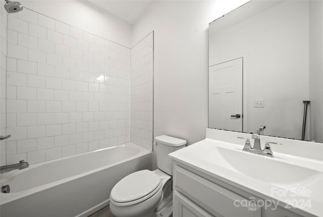 full bathroom with vanity, tiled shower / bath combo, and toilet