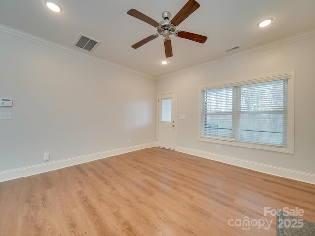 spare room featuring ceiling fan, light hardwood / wood-style flooring, and ornamental molding