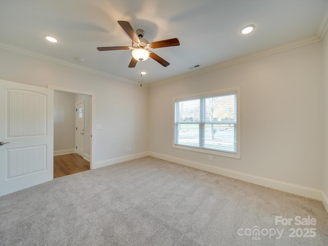 spare room with carpet, ceiling fan, and ornamental molding