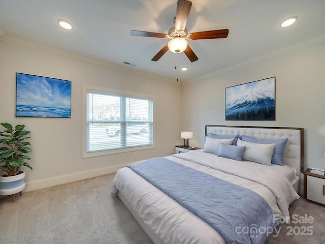 carpeted bedroom featuring ceiling fan and crown molding