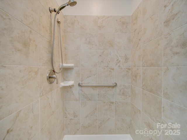 bathroom with tiled shower