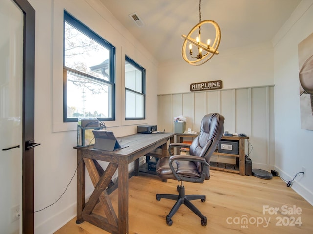 office featuring an inviting chandelier, light hardwood / wood-style flooring, and crown molding