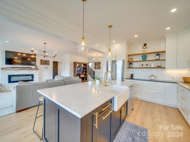 kitchen featuring white cabinets, pendant lighting, and stainless steel appliances