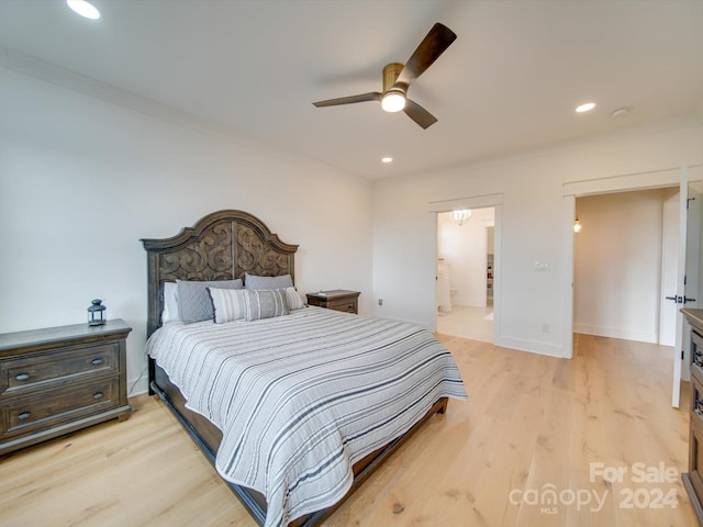 bedroom featuring ceiling fan, crown molding, ensuite bathroom, and light hardwood / wood-style flooring