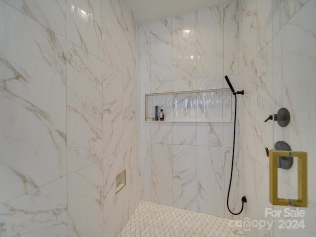 bathroom with a tile shower