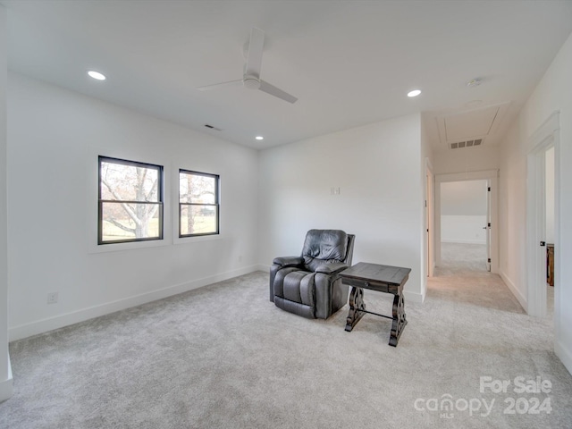 sitting room featuring ceiling fan and light colored carpet