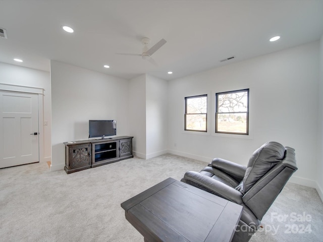 living room featuring light carpet and ceiling fan