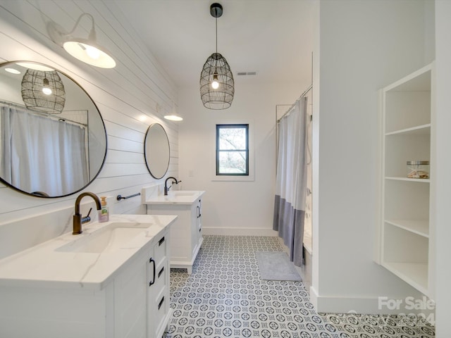 bathroom with tile patterned flooring and vanity