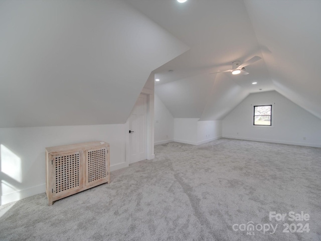 bonus room featuring light carpet, ceiling fan, and vaulted ceiling